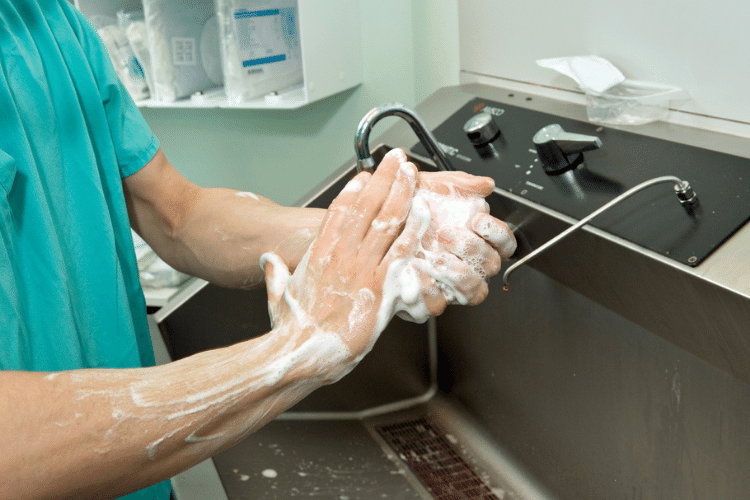 A person washing their hands in a healthcare setting