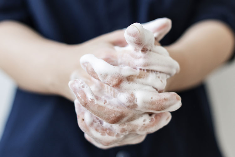 Soap foam-covered clasped hands